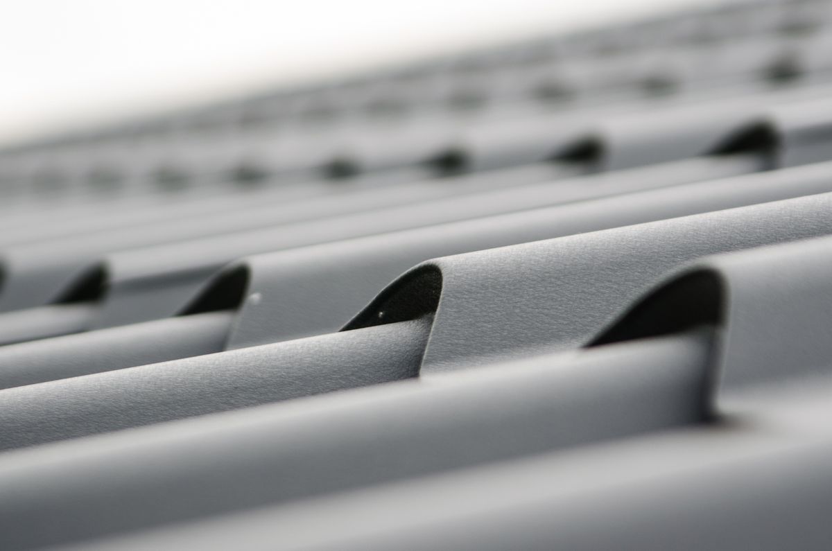 Close detail of overlapping gray metal roof tiles