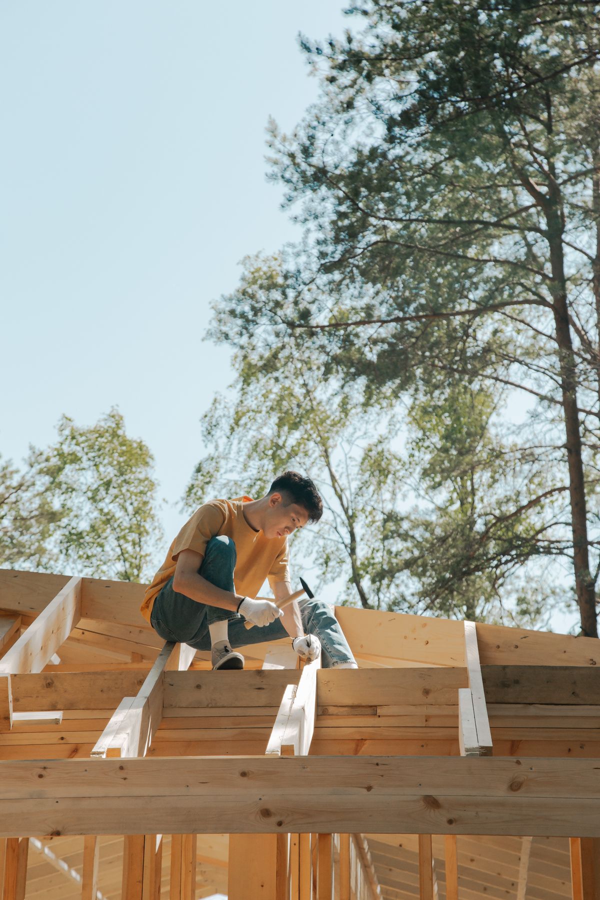 A carpenter fastening timber in a roof frame